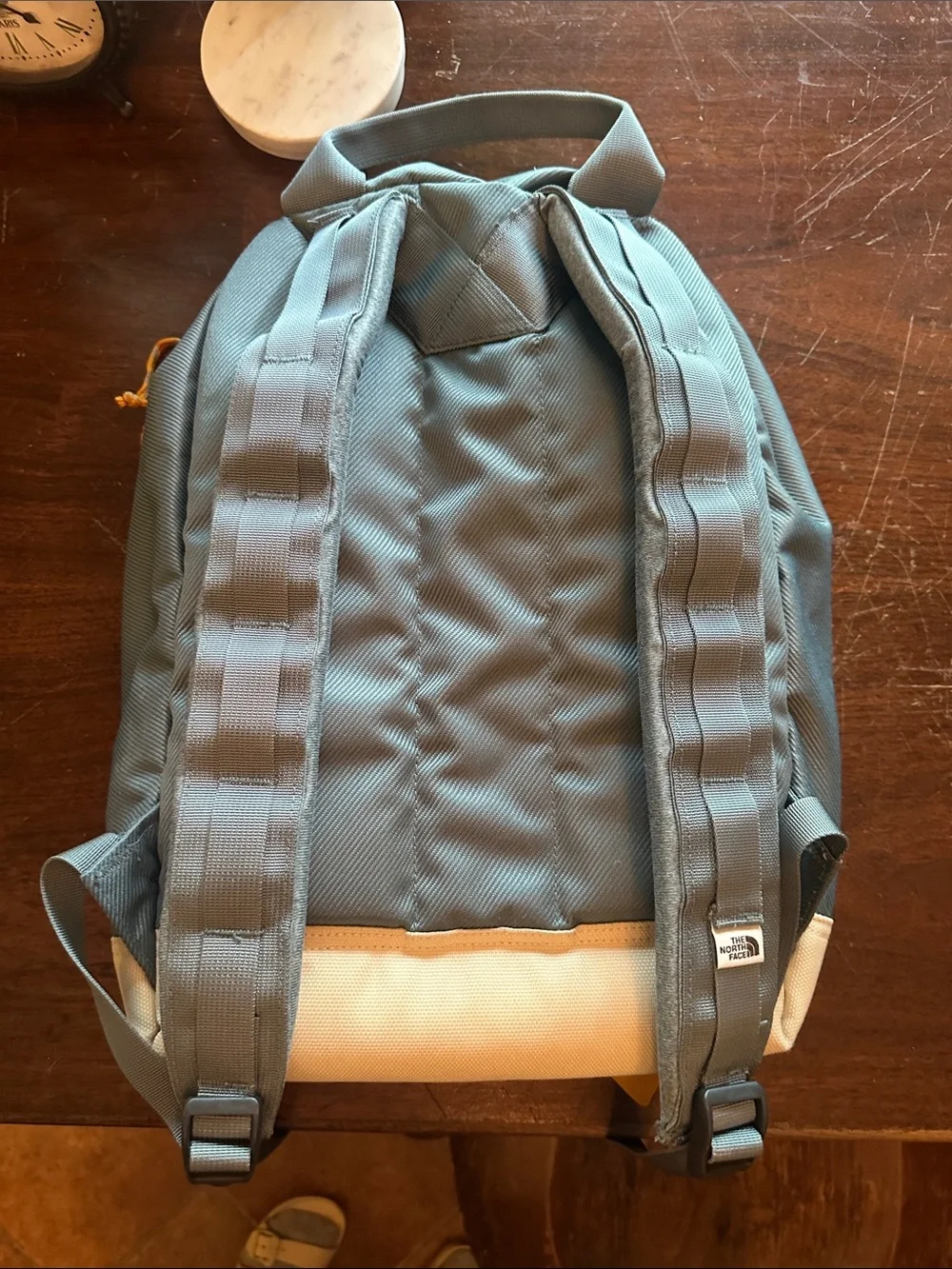 The North Face Light Blue Backpack with White Base and Yellow Accents